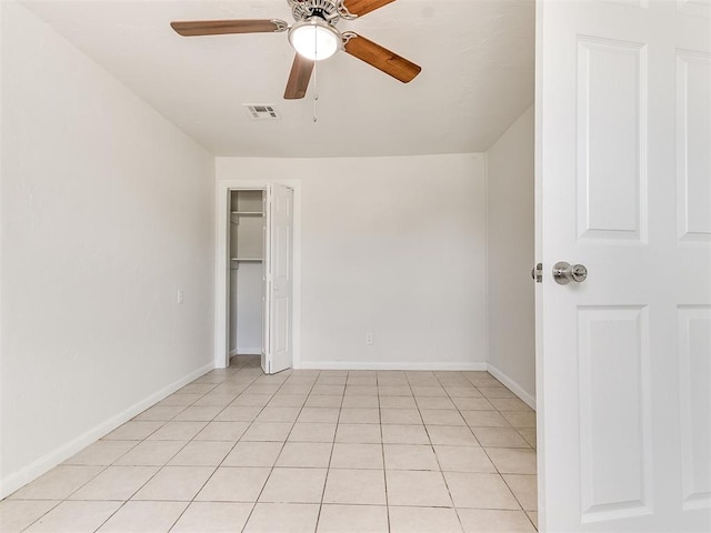 unfurnished room with light tile patterned floors and ceiling fan