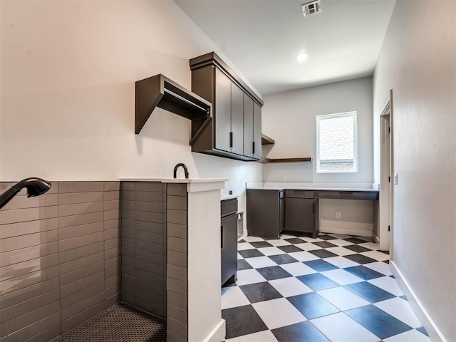 kitchen featuring dark brown cabinetry