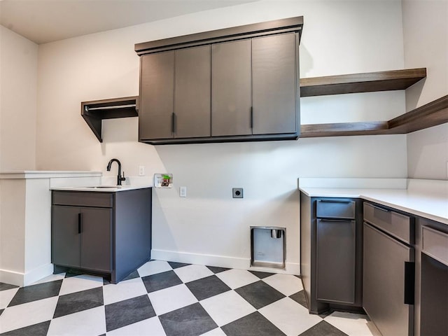 interior space featuring sink, cabinets, and hookup for an electric dryer