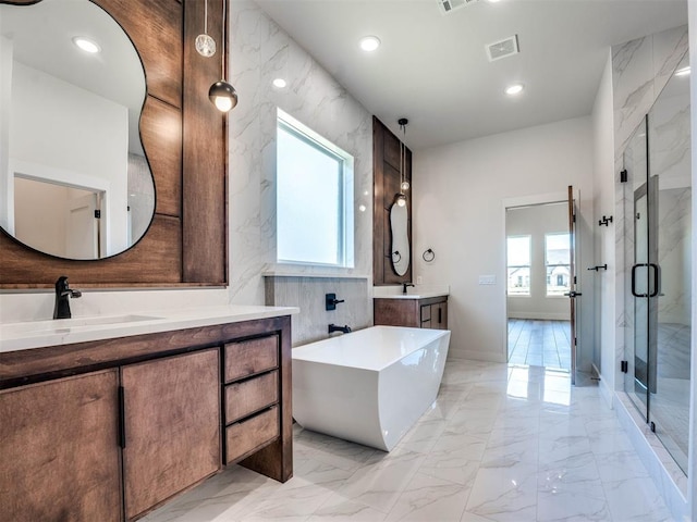 bathroom featuring plus walk in shower, vanity, tile walls, and a healthy amount of sunlight