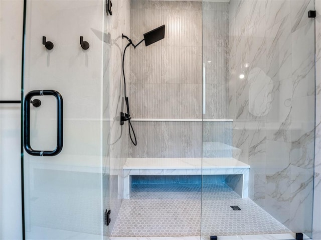 bathroom with a shower with shower door