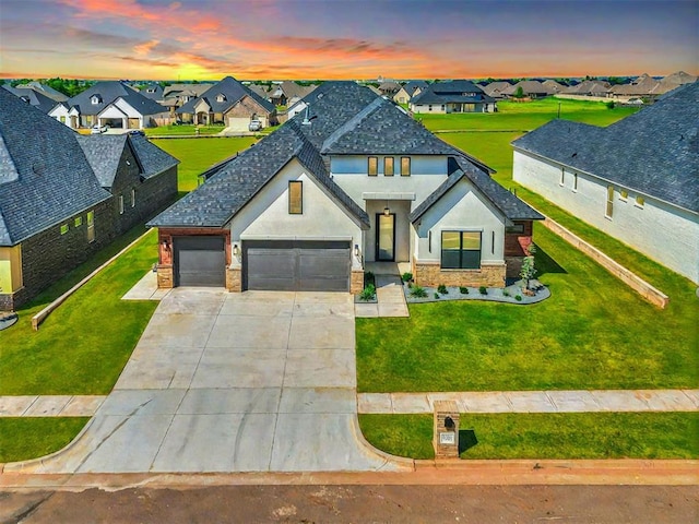 view of front of property with a lawn and a garage