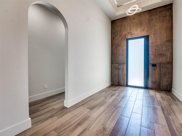 foyer featuring wood walls and light hardwood / wood-style floors