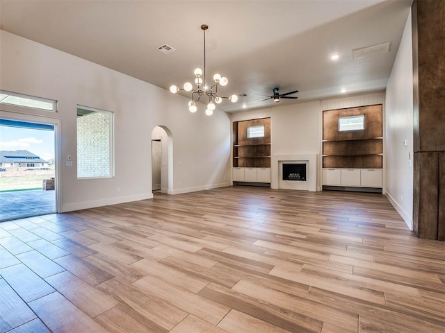 unfurnished living room with light hardwood / wood-style floors and ceiling fan with notable chandelier