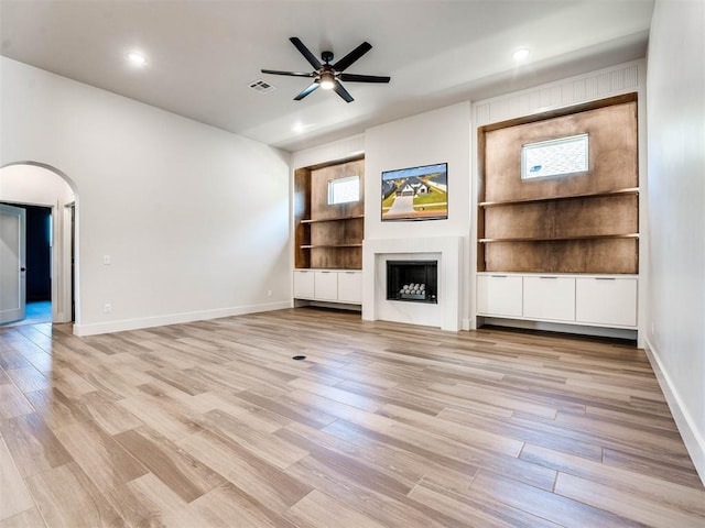 unfurnished living room featuring a wealth of natural light and light wood-type flooring