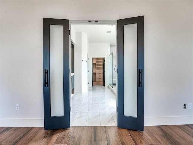 hallway with light hardwood / wood-style flooring