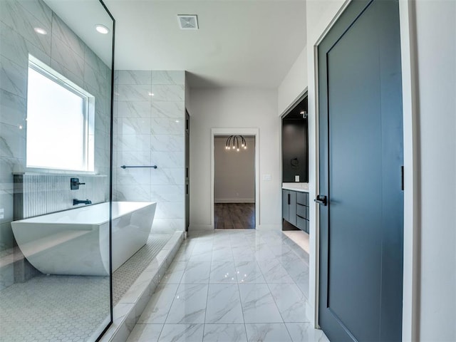 bathroom with vanity, separate shower and tub, and tile walls