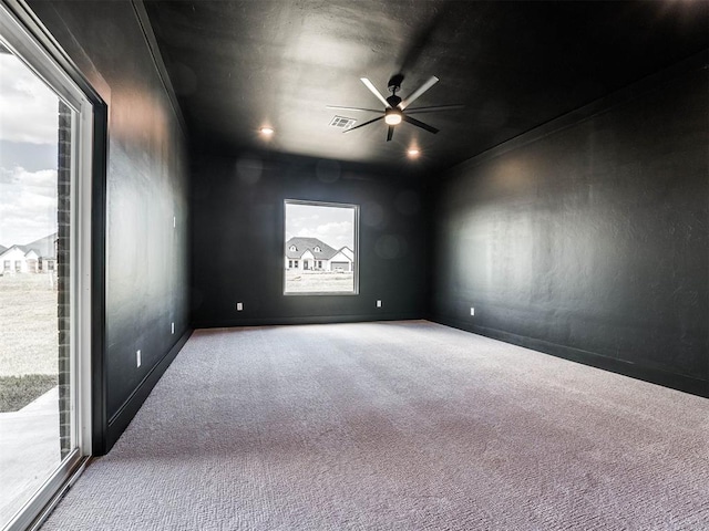 unfurnished room with carpet flooring, ceiling fan, and ornamental molding