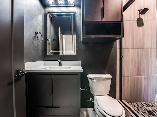 bathroom featuring walk in shower, vanity, and toilet