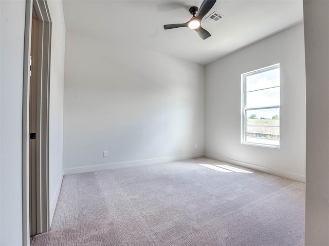 spare room featuring ceiling fan and light colored carpet