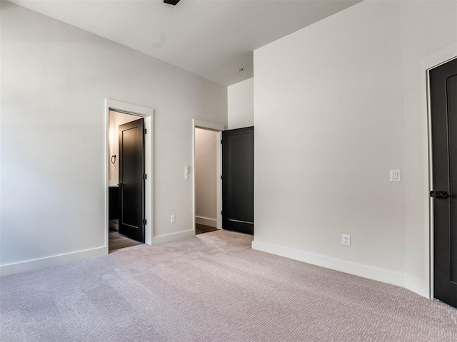 unfurnished bedroom with light colored carpet