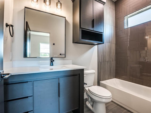 full bathroom featuring vanity, a healthy amount of sunlight, toilet, and tiled shower / bath