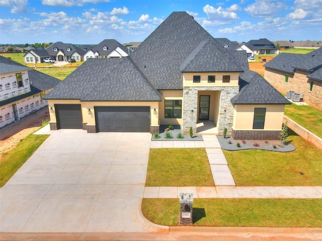 view of front of property featuring a garage and a front lawn