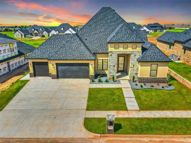 view of front of home featuring a yard and a garage