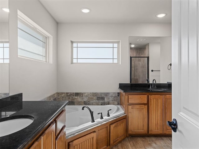 bathroom featuring vanity, hardwood / wood-style flooring, and independent shower and bath