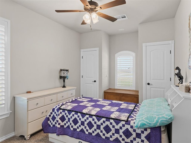 bedroom featuring light colored carpet and ceiling fan