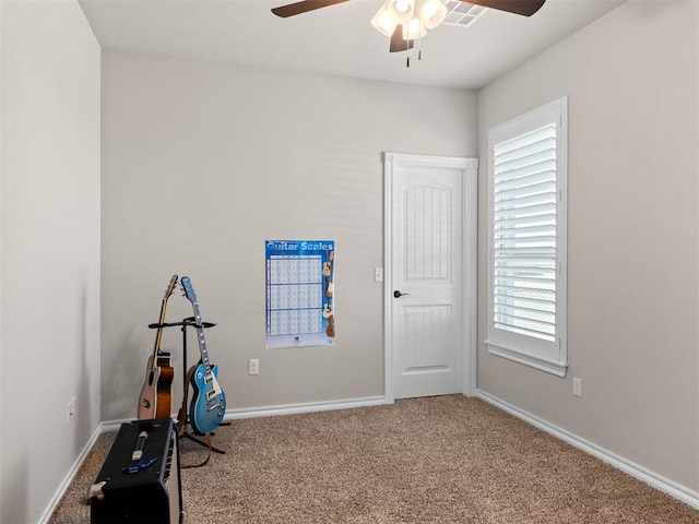 exercise area featuring carpet and ceiling fan