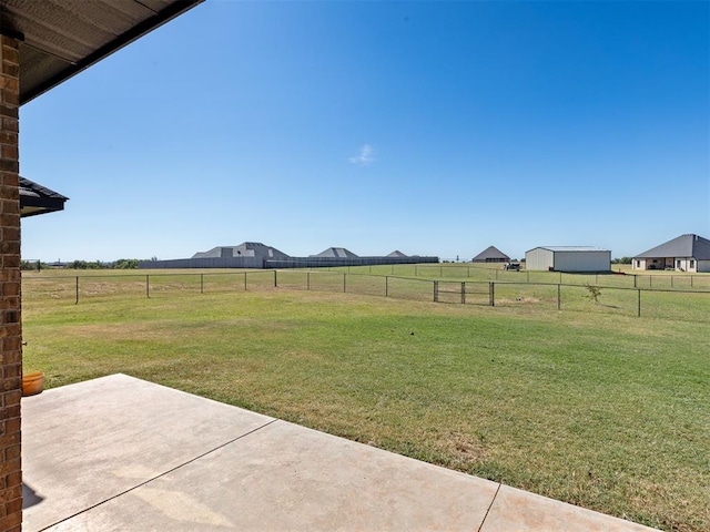 view of yard with a rural view and a patio