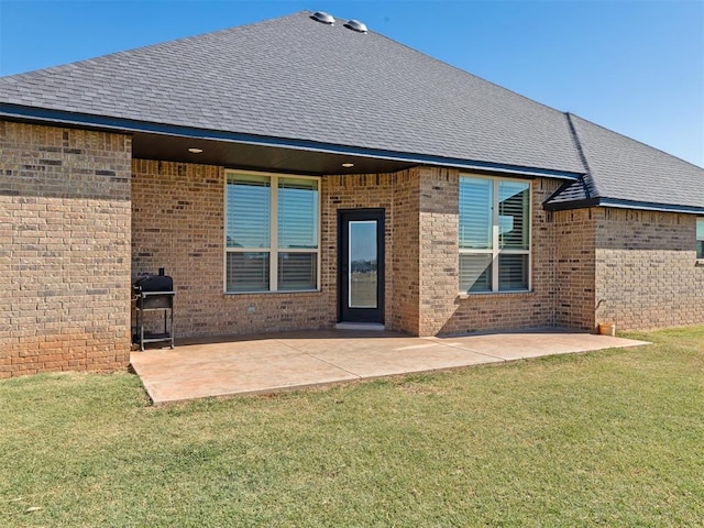 back of property with a patio area and a lawn