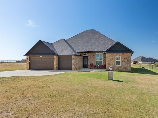 view of front facade with a garage and a front lawn