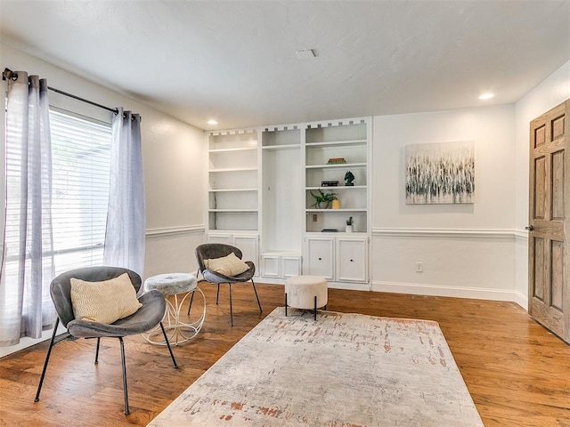 sitting room with wood-type flooring