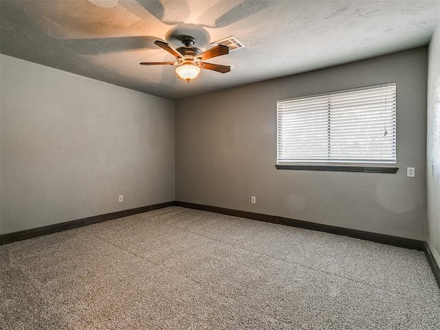 spare room featuring carpet floors and ceiling fan