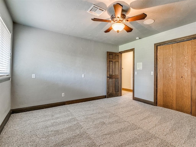 unfurnished bedroom featuring ceiling fan, carpet floors, and a closet