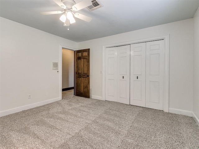 unfurnished bedroom featuring ceiling fan, a closet, and carpet floors