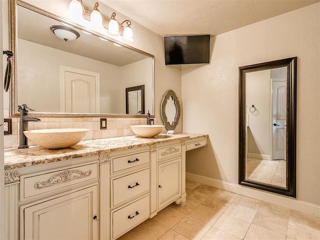 bathroom with tile patterned floors, vanity, and tasteful backsplash