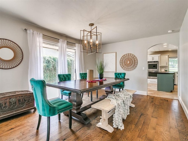 dining area featuring hardwood / wood-style floors and a notable chandelier