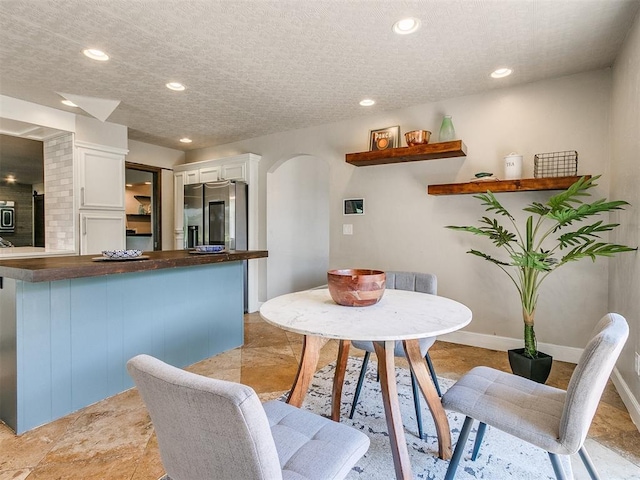 dining area with a textured ceiling