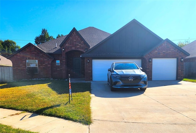 view of front of home featuring a garage and a front lawn