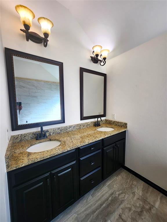 bathroom with vanity and an inviting chandelier