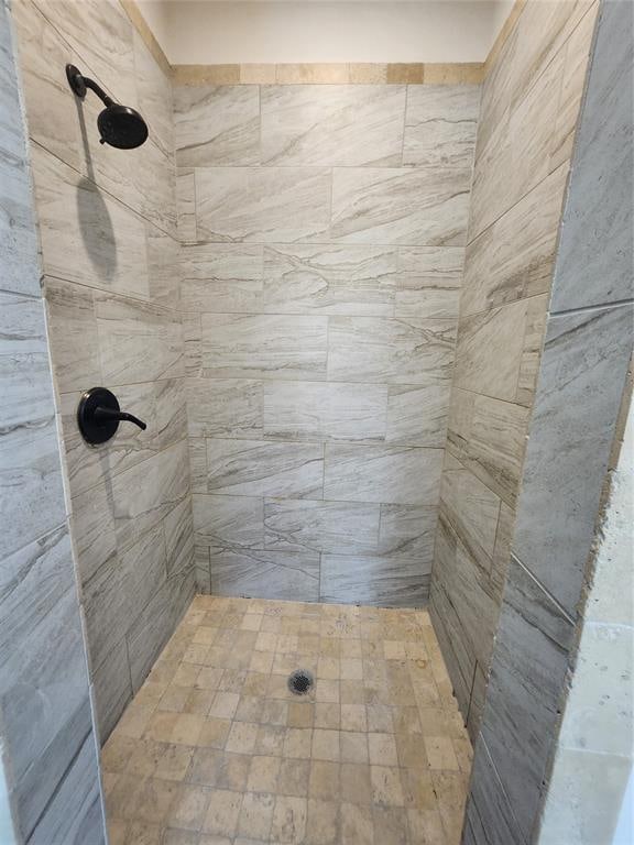 bathroom with a tile shower