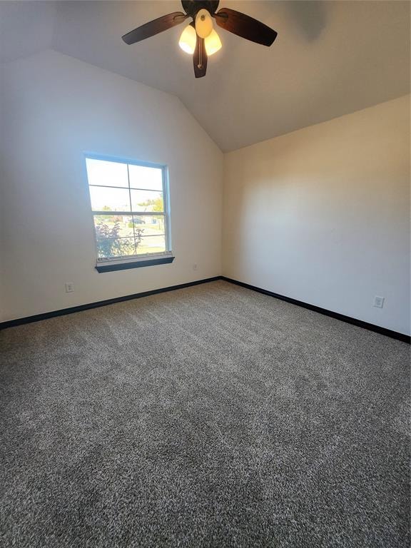 spare room with ceiling fan, lofted ceiling, and carpet floors