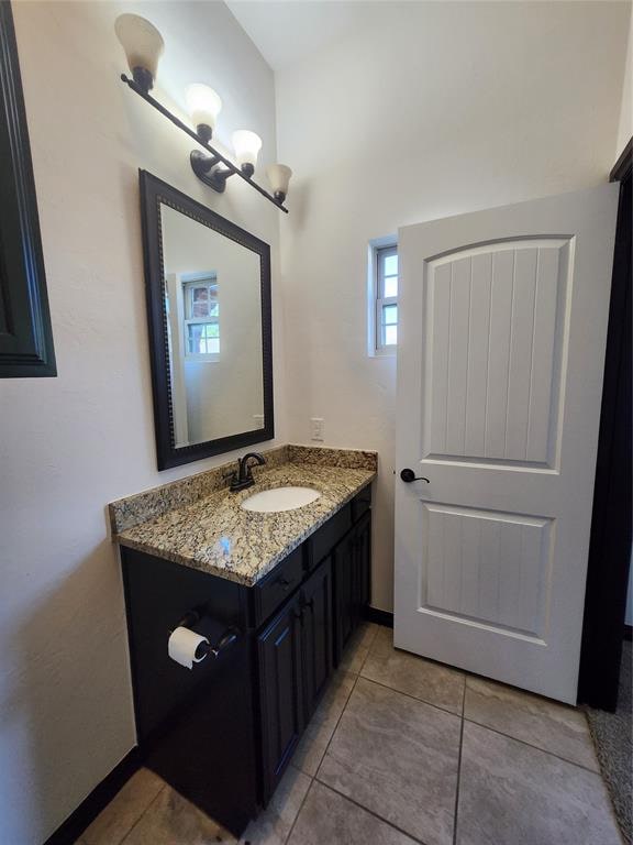 bathroom with tile patterned flooring and vanity