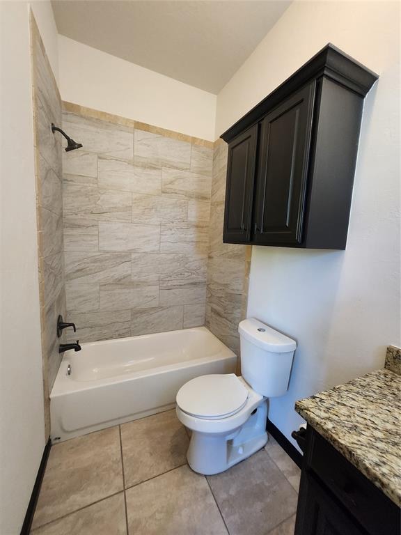 full bathroom featuring tile patterned flooring, vanity, toilet, and tiled shower / bath