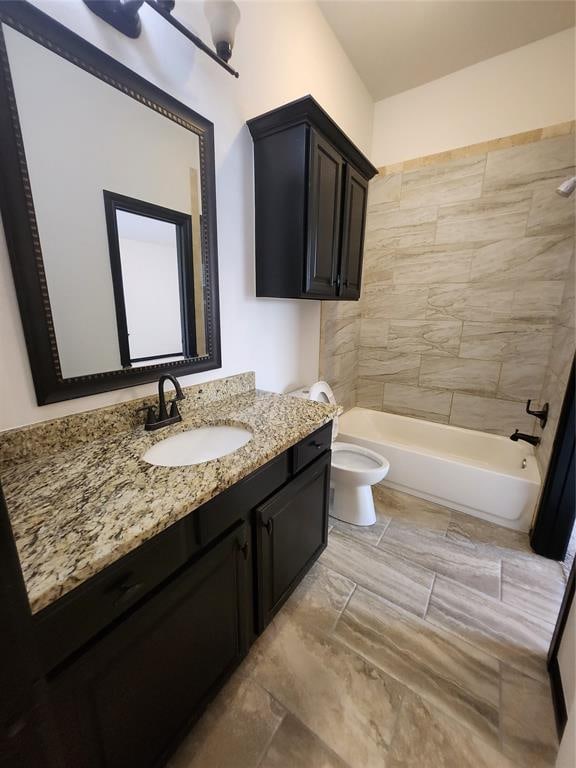 full bathroom with vanity, toilet, and tiled shower / bath