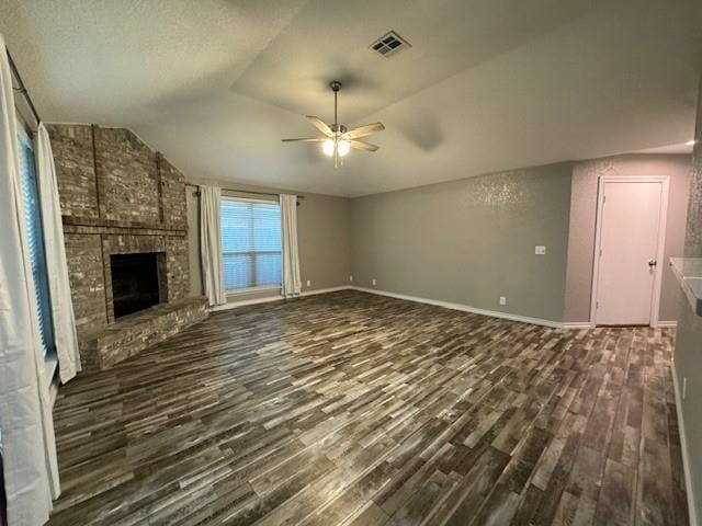 unfurnished living room featuring a fireplace, dark hardwood / wood-style flooring, ceiling fan, and lofted ceiling