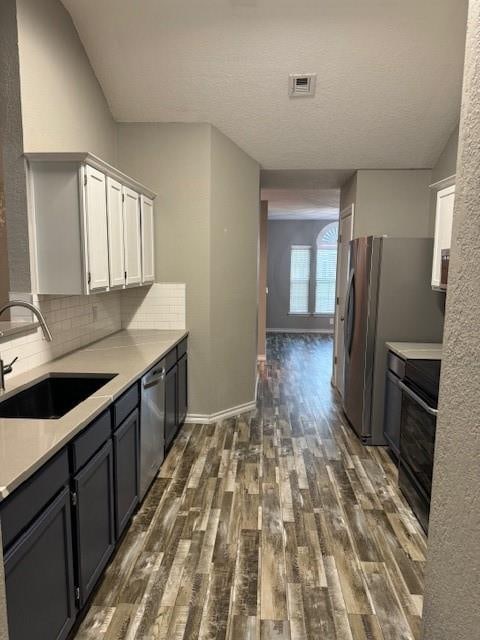 kitchen with white cabinetry, sink, black electric range oven, stainless steel dishwasher, and dark hardwood / wood-style floors