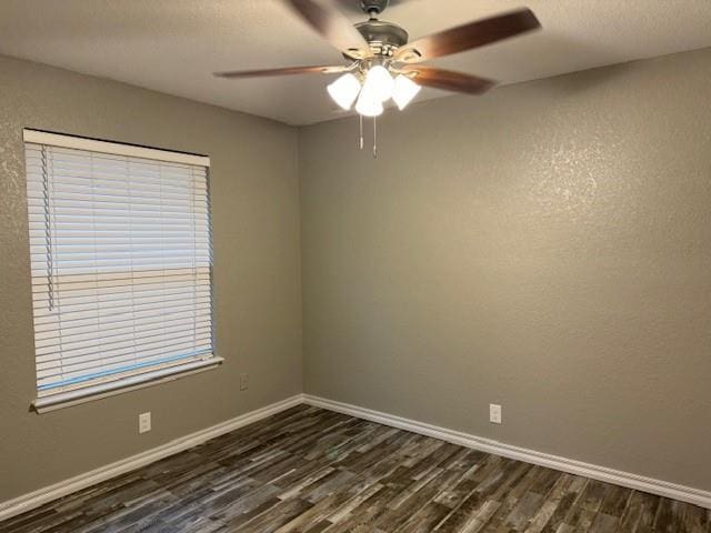 spare room with ceiling fan and dark hardwood / wood-style floors