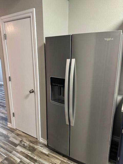 kitchen featuring stainless steel fridge and light hardwood / wood-style floors