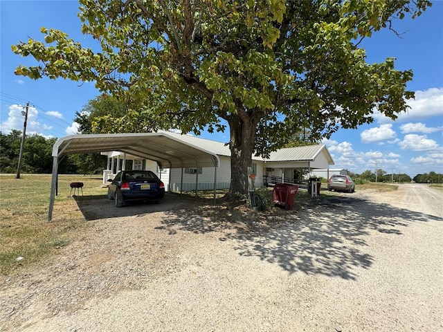 view of front of house featuring a front lawn and a carport