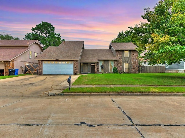 view of front facade with a garage and a yard