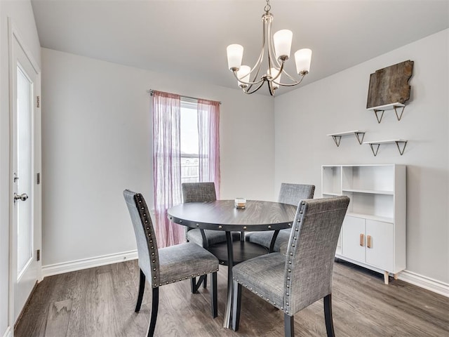 dining space featuring hardwood / wood-style flooring and a notable chandelier