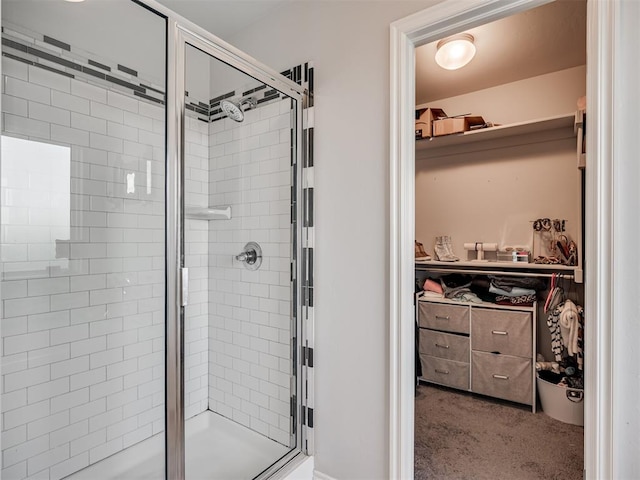 bathroom featuring a shower with shower door