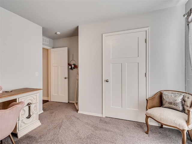 living area featuring light carpet