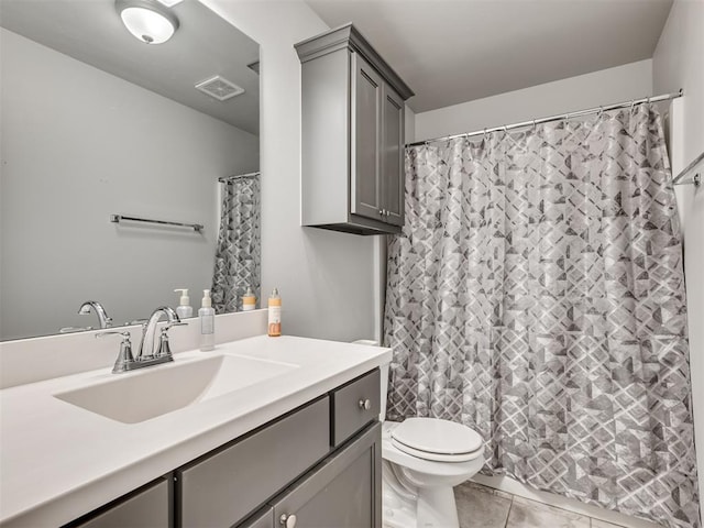 bathroom with tile patterned floors, vanity, toilet, and walk in shower