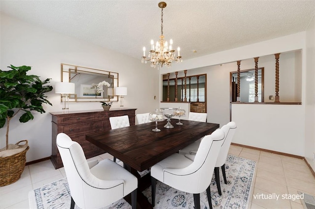 dining space featuring a chandelier, a textured ceiling, and light tile patterned flooring