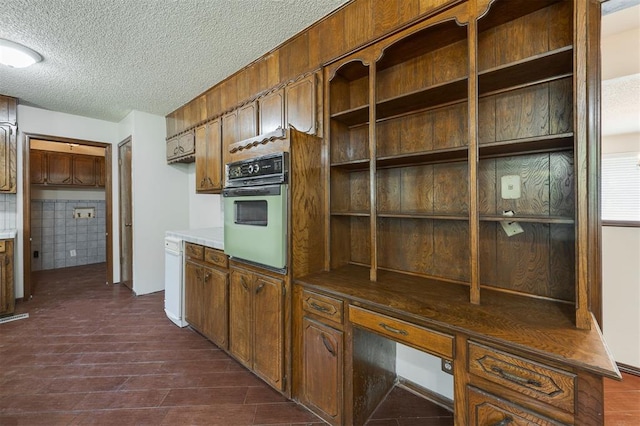 kitchen featuring oven and a textured ceiling